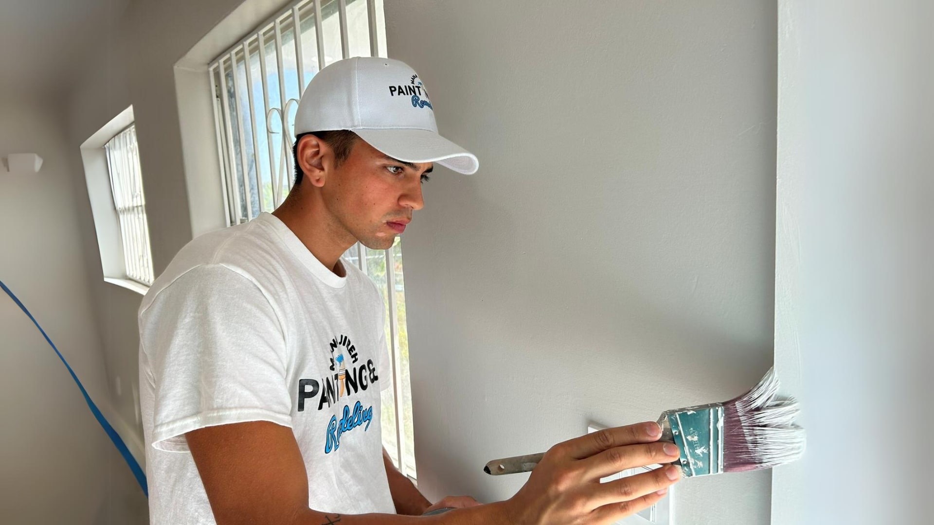 A Mana Painting Services painter carefully cutting in a wall edge