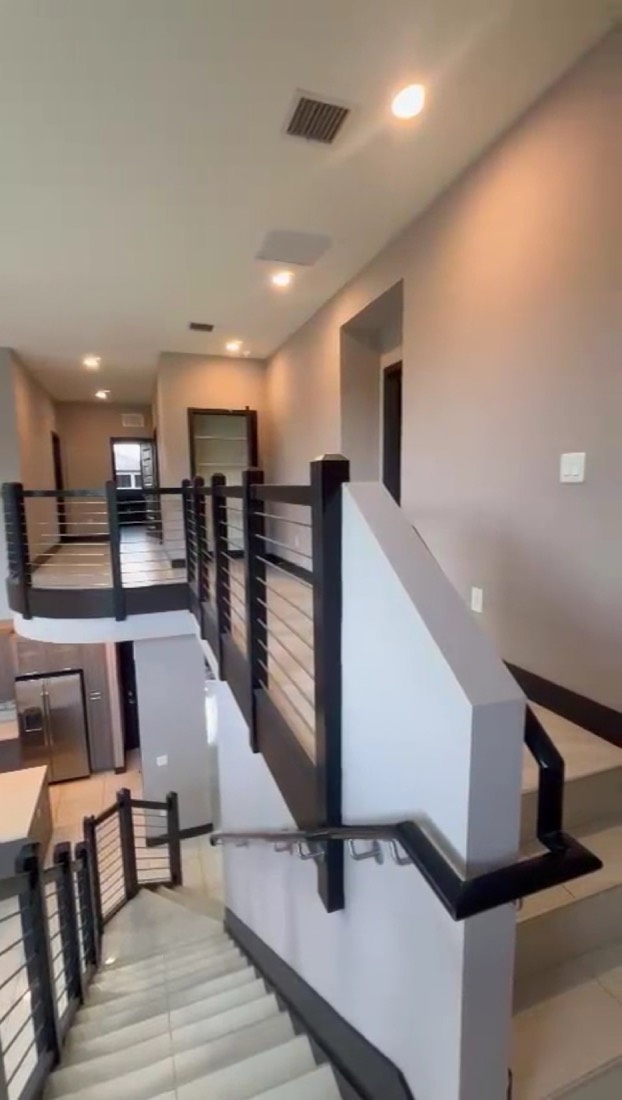 Modern staircase with cable railing after an interior repaint