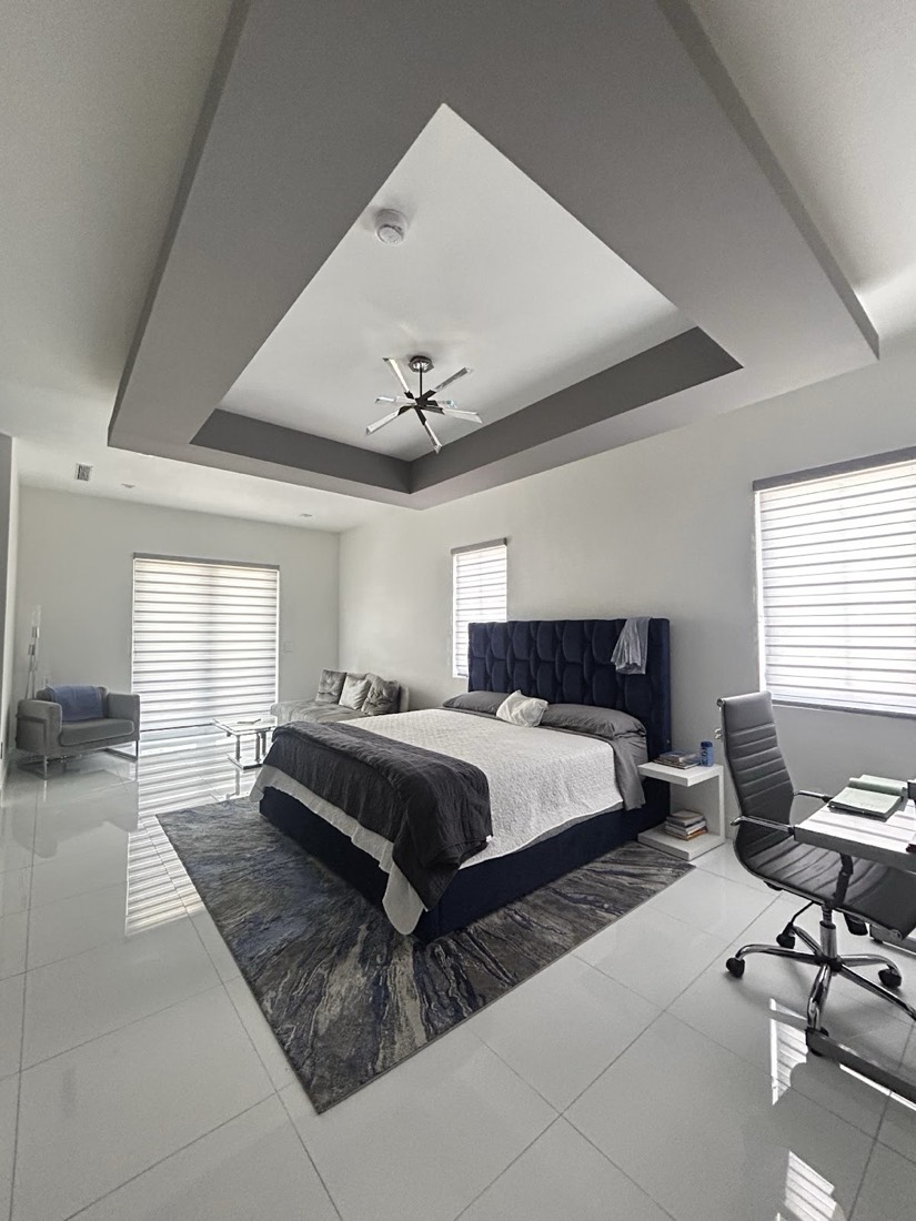 Freshly painted bedroom with a gray tray ceiling — interior painting in Miami