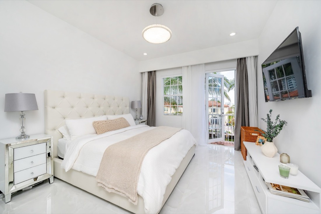 Bright white bedroom after interior painting by Mana Painting Services